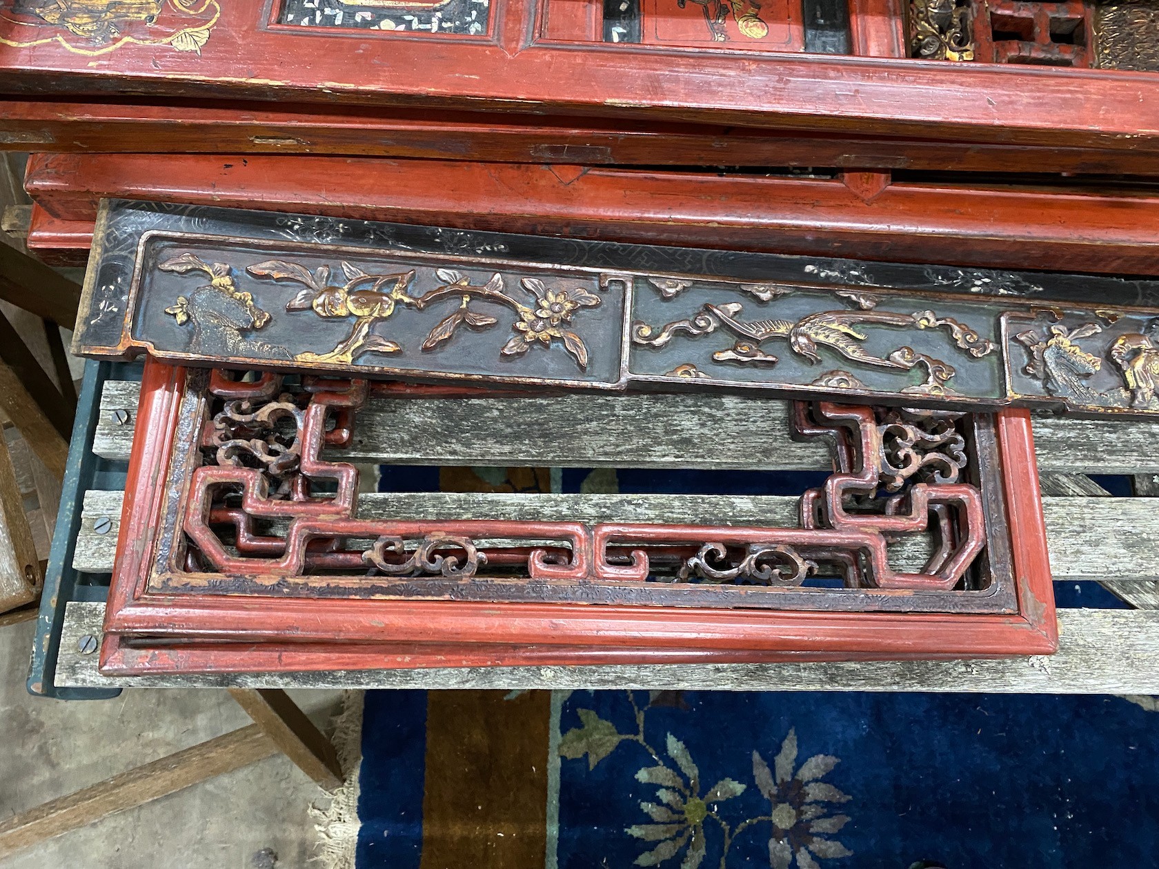 Nine sections of a Chinese red lacquered cabinet, with gilt figural decoration